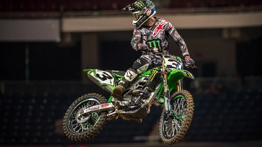 Amazing flying profile photo of a Monster 250cc motocross in a race