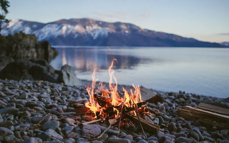 Stock photo of a camp on the shore of the stunning lake for travel lovers 
