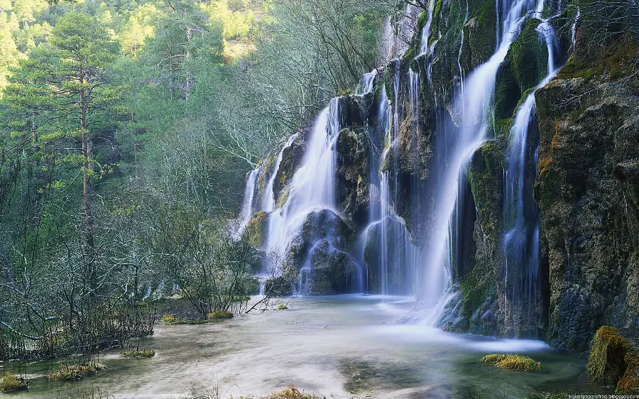 Stunning wallpaper of a pristine waterfall and river
