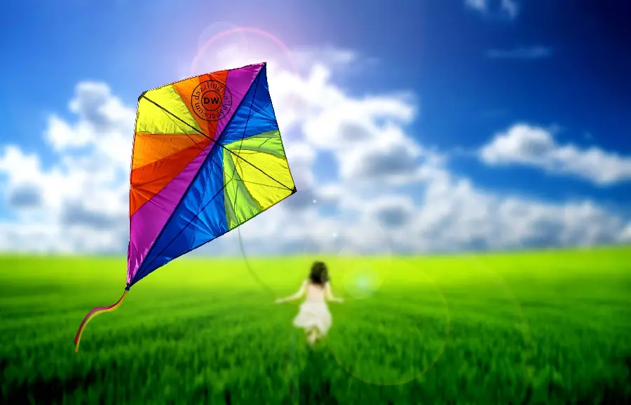 Download simple wallpaper with a little girl playing with a giant kite