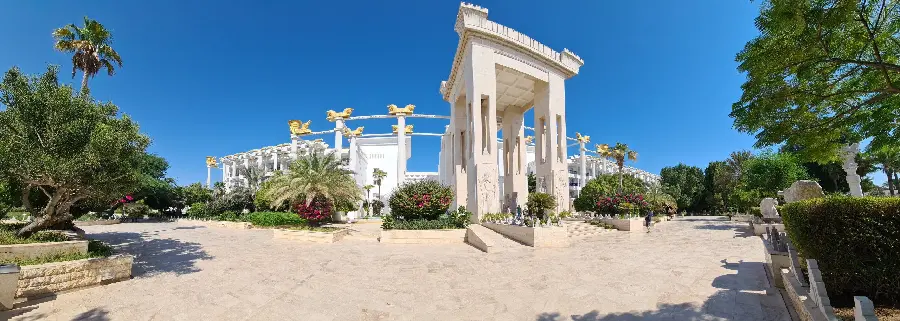 Background image of the facade of the Grand Dariush Hotel, a luxurious and well-equipped hotel
