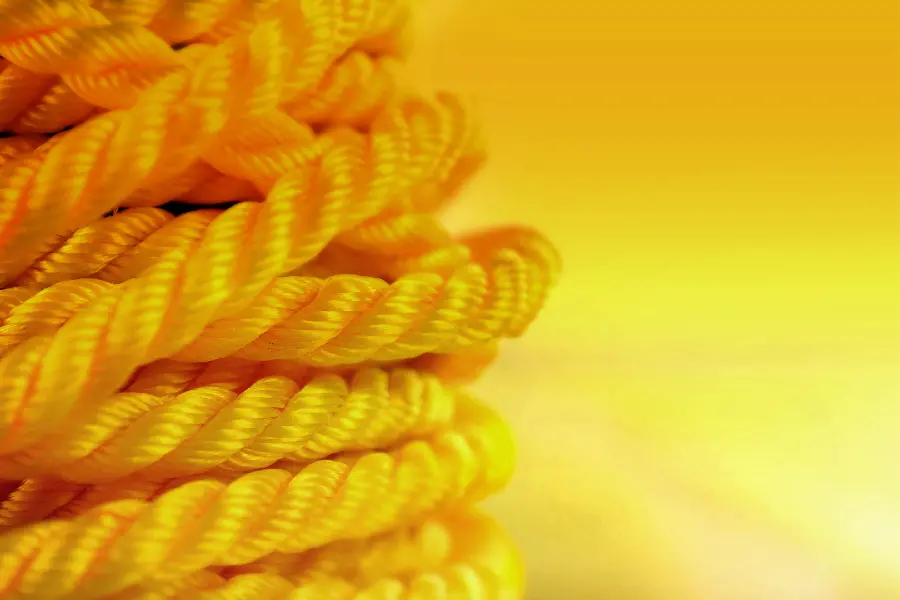A wallpaper photo of a yellow rope up close in a faded and blurred background