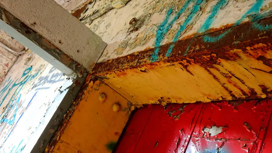 Interesting photo of the interior of an industrial building with rusty walls