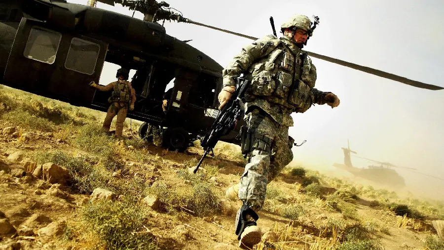 Military soldiers getting off the army helicopter