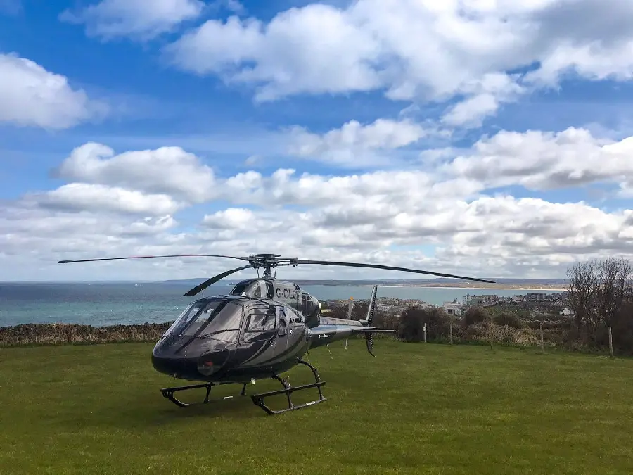 Private helicopter stock photo with blue sky full of clouds