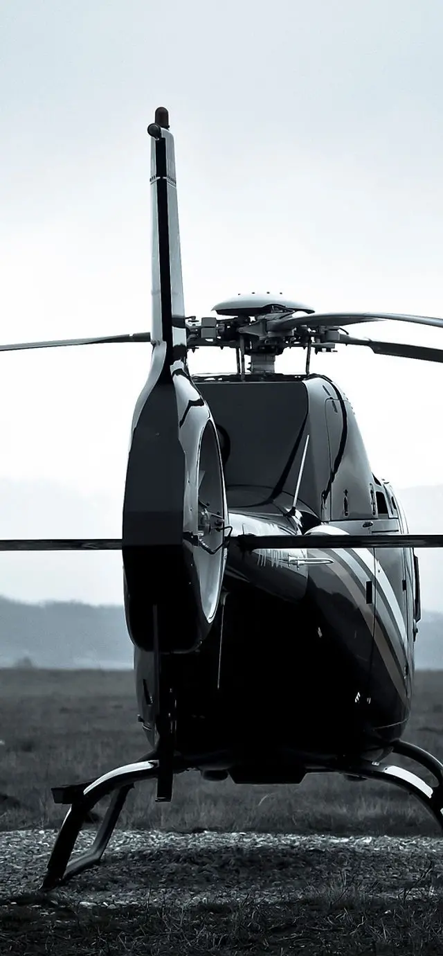 Background photo of a dark and advanced private helicopter design 
