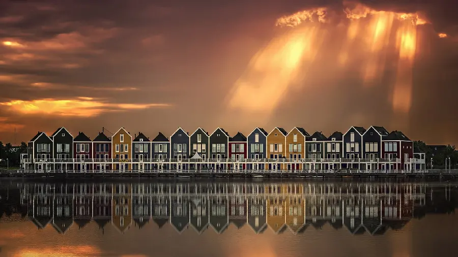 Very beautiful background of cottages by the water in the sunset sky 