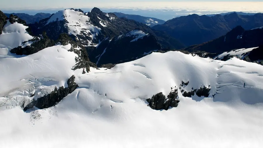 Wallpaper of mountains surrounded by heavy snow for desktop