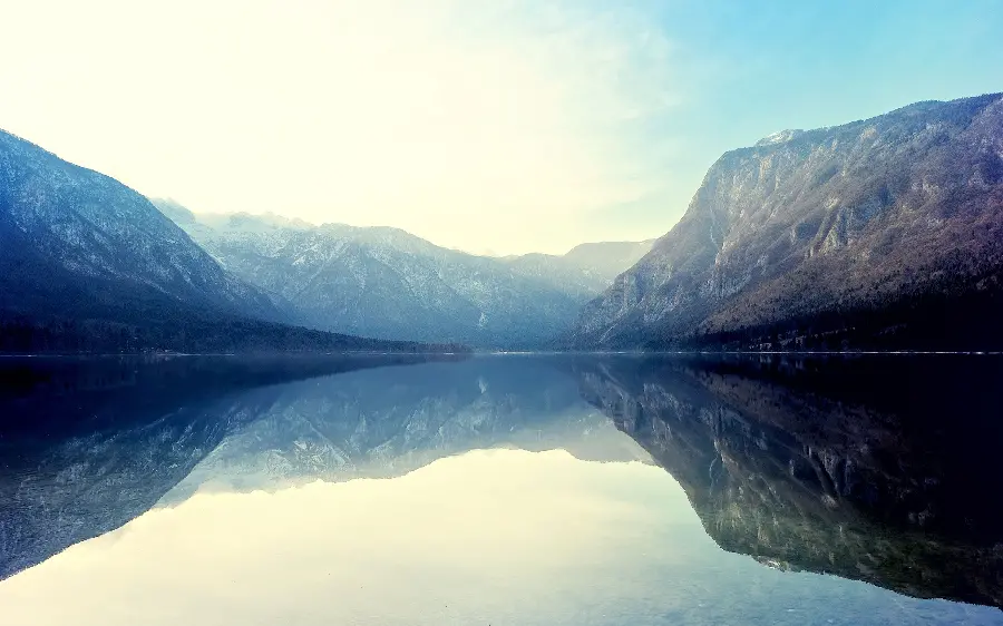 Download a photo of a clear full-water lake among high and solid mountains