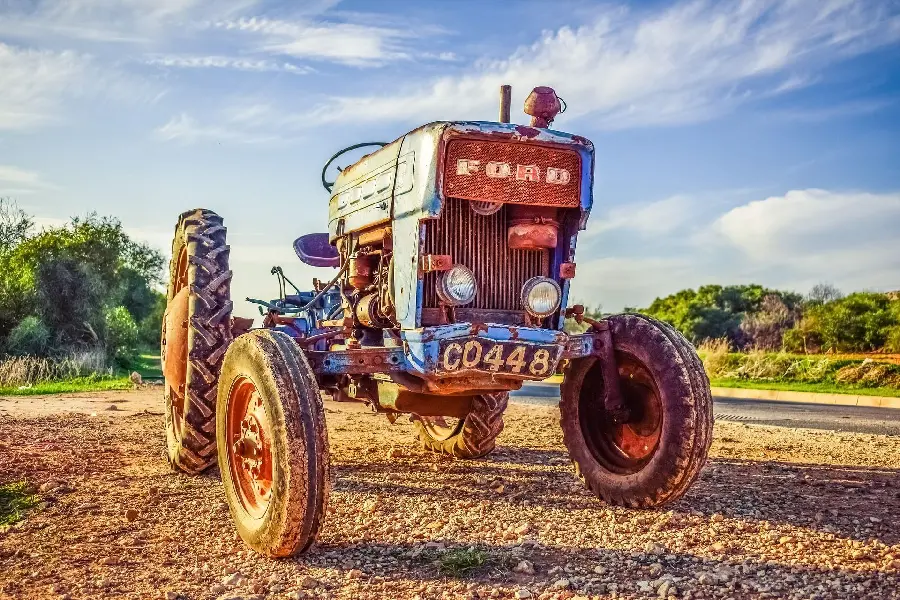 Stock photo of an old Ford tractor abandoned in a meadow