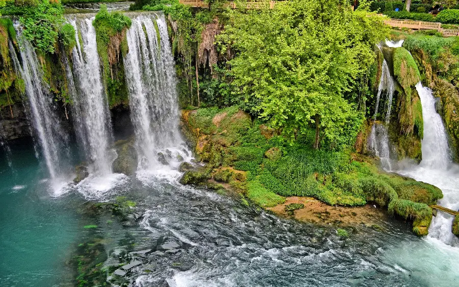 A very beautiful and pleasant picture of a tourist attraction of a waterfall and lush trees
