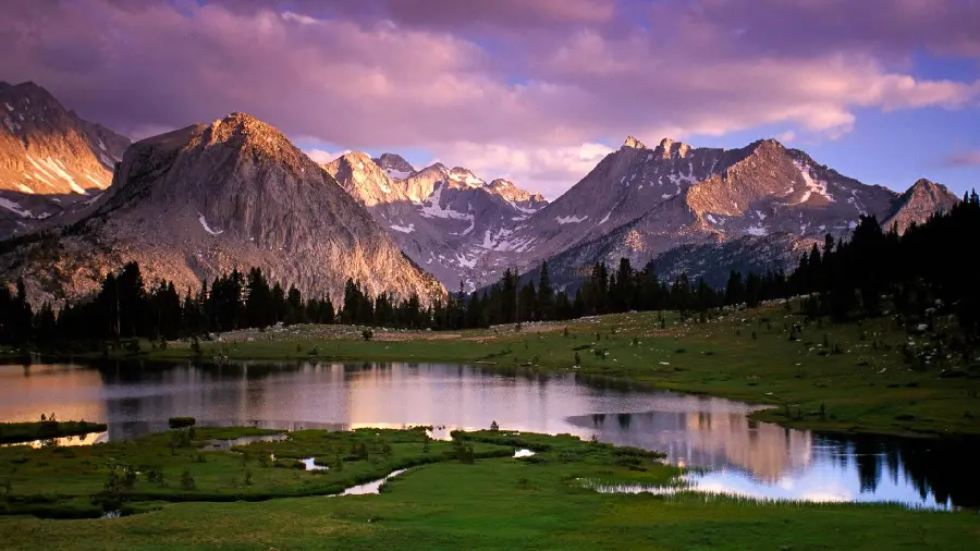 Download the stylish and incredible image of a forested lake with water between high mountains 
