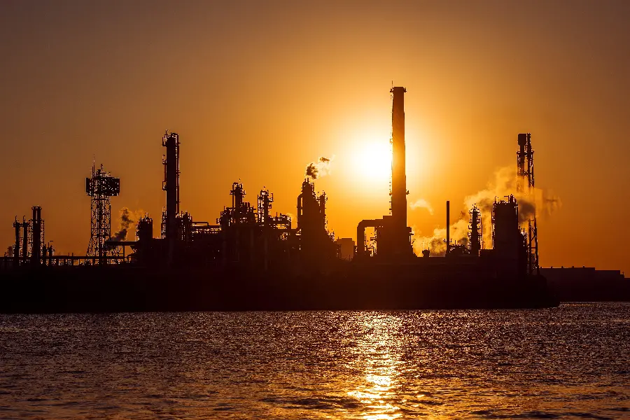 Wallpaper of an industrial facility and refinery at sunset