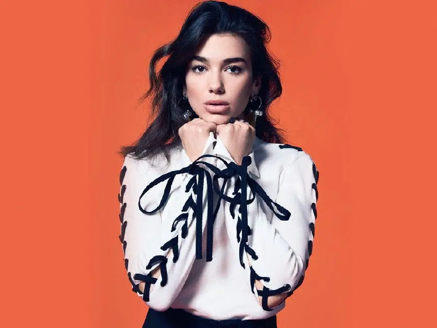 High-quality wallpaper of the famous face of Dua Lipa with an orange background
