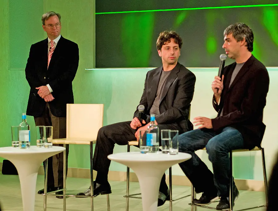 Photo taken of Larry Page and Sergey Brin talking to the host