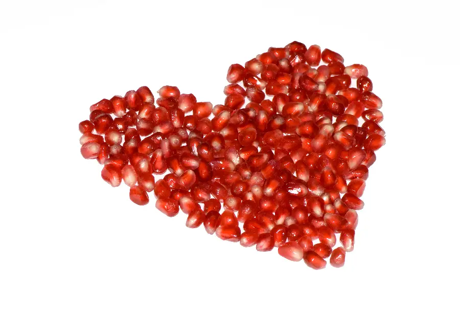 Very cool and creative stock of pomegranate seeds arranged in the shape of a heart for Valentine's Day