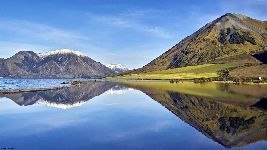 The best photo of a forested lake with water between mountains according to the public 