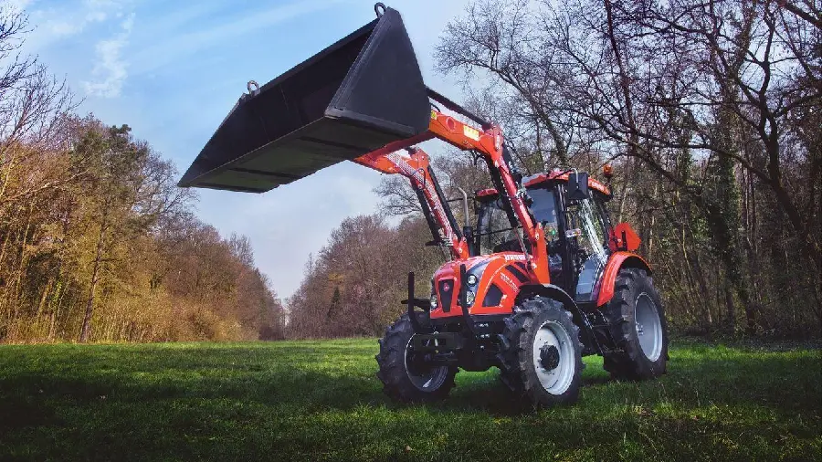 Photo of a red tractor excavator working in a field