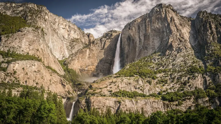 A new background 1403 of a waterfall in the heart of the mountain and rocks
