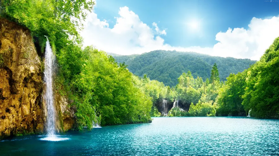 Download the incredibly beautiful and impressive nature photo of a mountain lake and a transparent waterfall