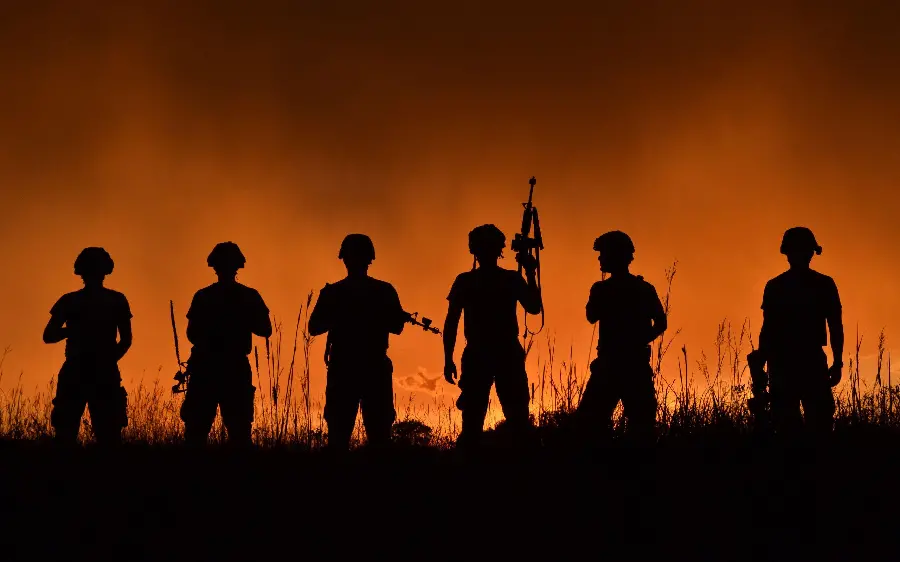 A photo of powerful soldiers with a beautiful sunset background