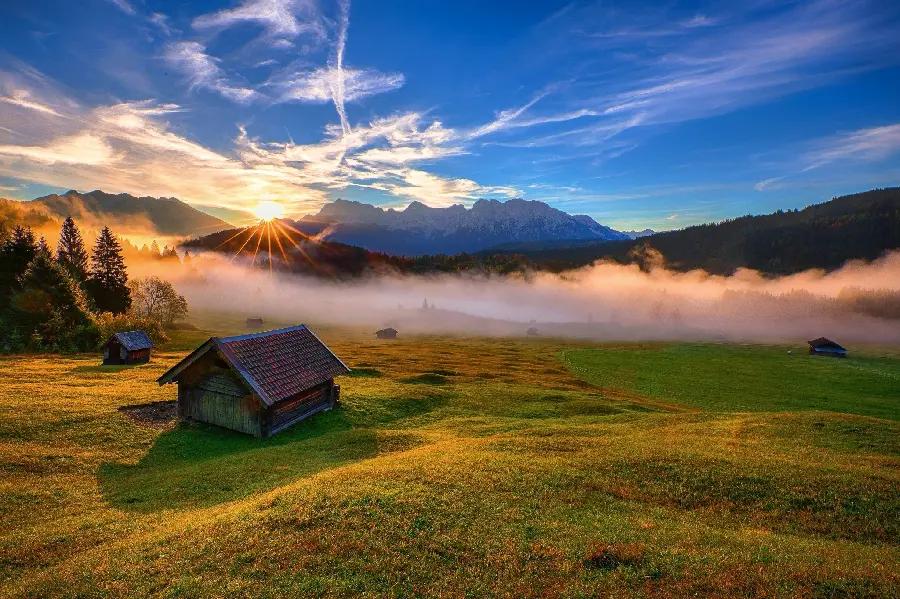 Download a dreamy background photo of a wooden hut in the meadows at sunrise