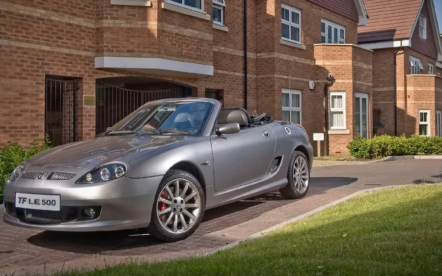 Stock image of a cool foreign car parked in a classy neighborhood 