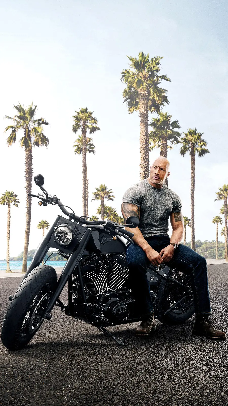 Photo taken of Dwayne Johnson next to an expensive and luxurious motorcycle