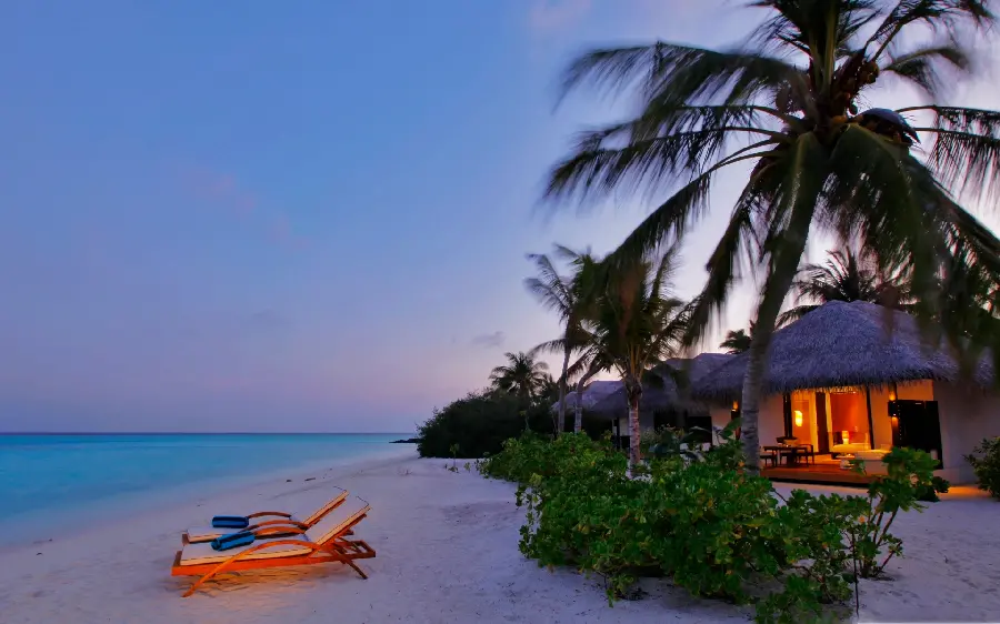 New stock of a luxurious and dreamy hotel by the water at sunset