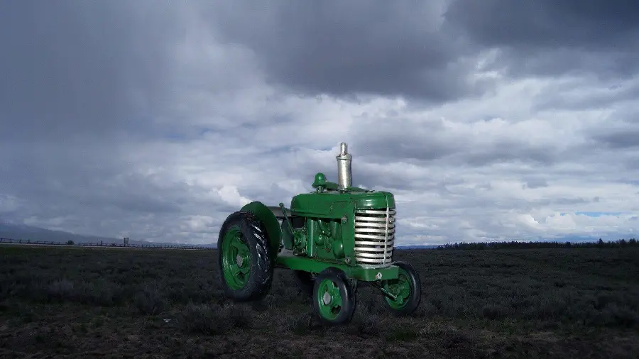 Tractor in an interesting and cloudy background Full HD