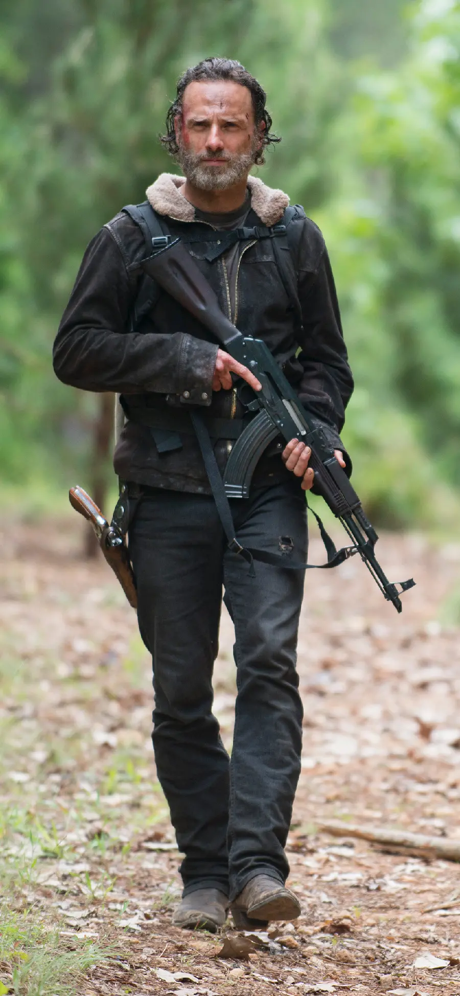 Rick Grimes' photo in the fifth season of the Walking Dead series with a gun 