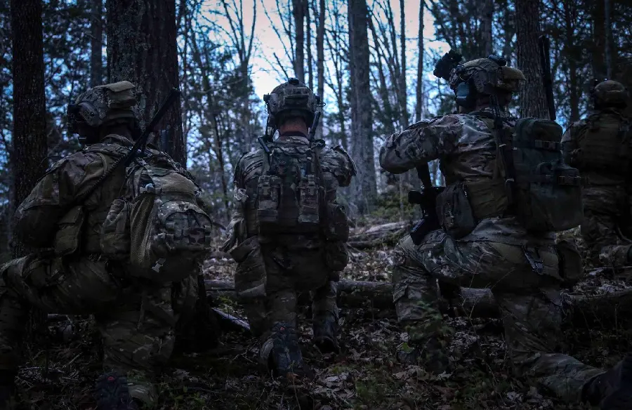 Photo of soldiers hiding among forest trees