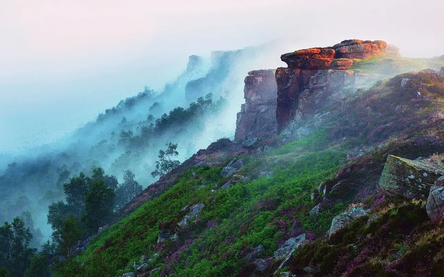 Download a photo of a mountain cliff in the fog for nature tourism 