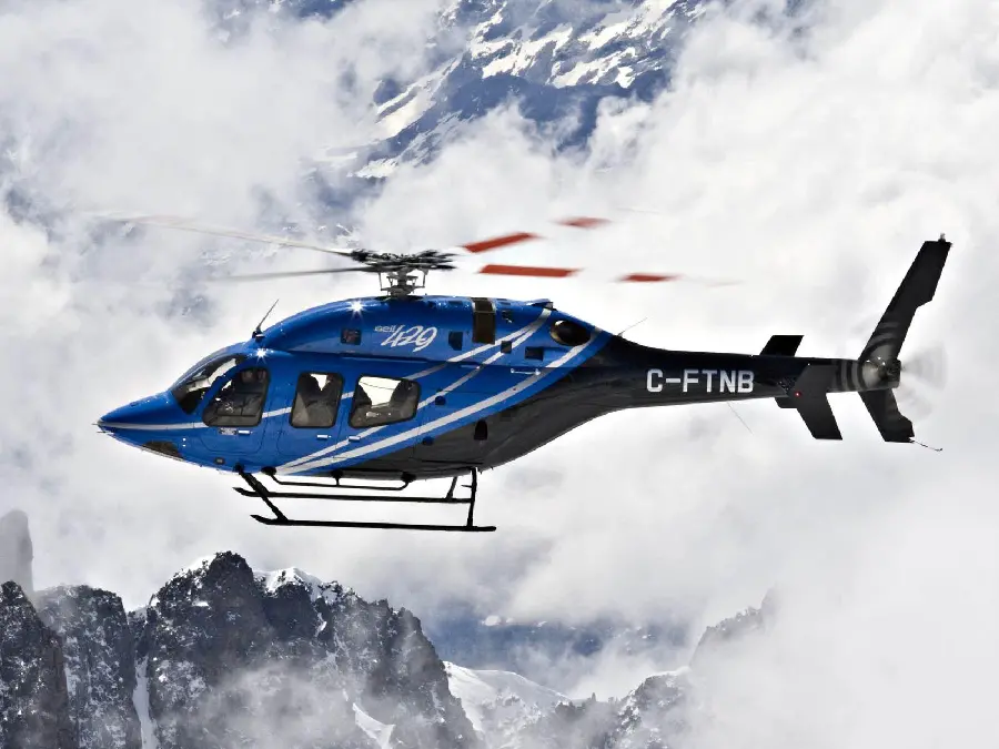 Download a photo of a private blue helicopter in cold, cloudy winter weather 