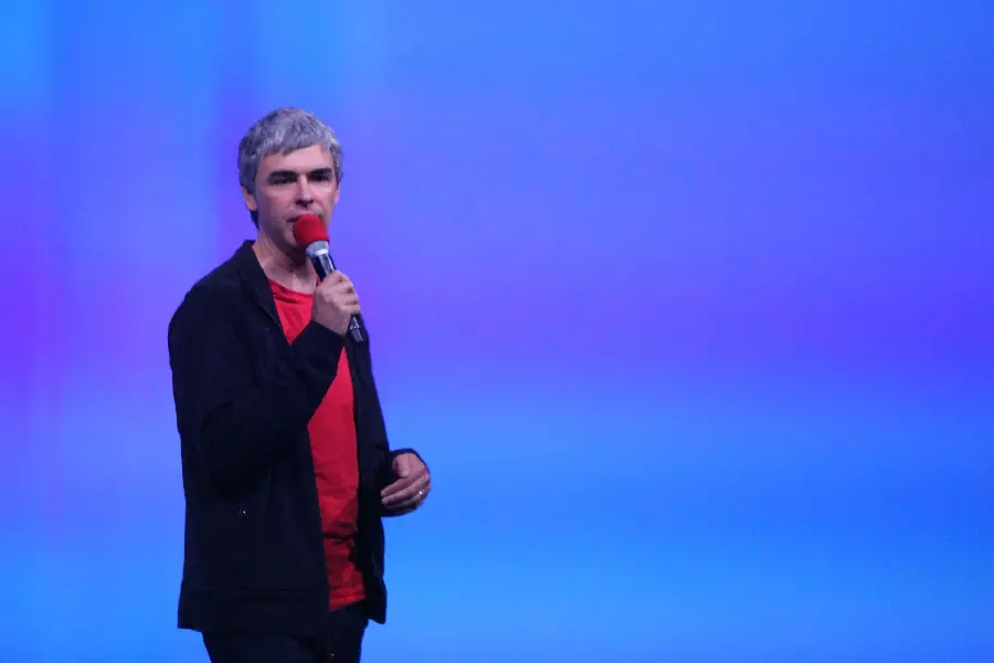 Background image of Larry Page with a simple blue background