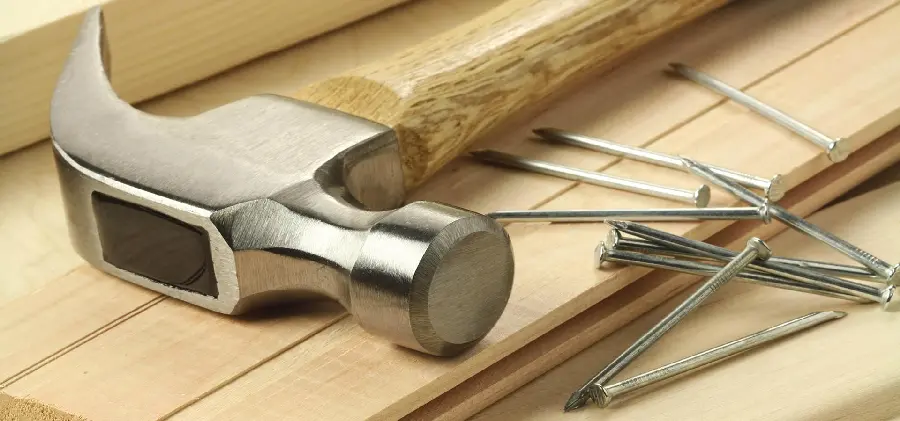 High-resolution image of nails and hammers, important carpentry tools