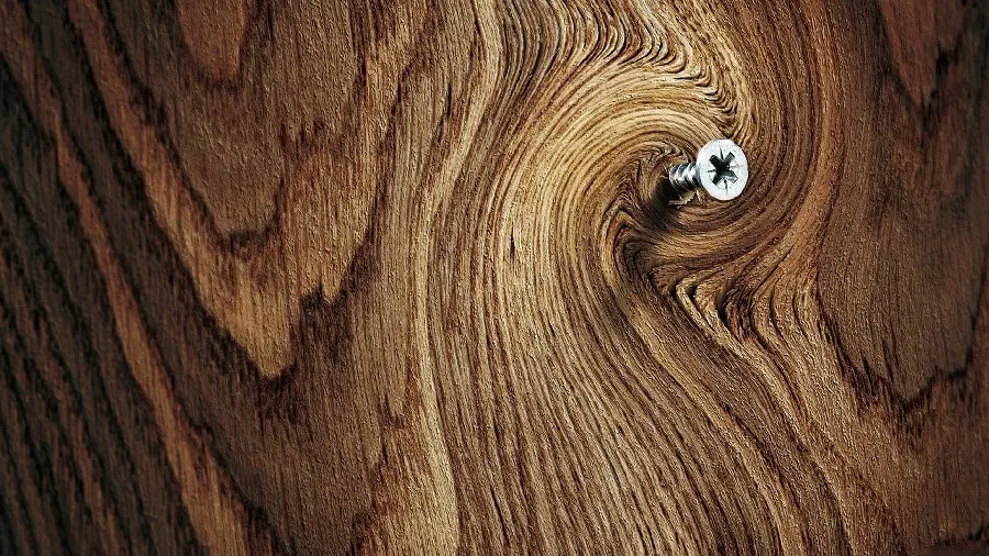 Photo of a screw stock on a wooden board related to carpentry