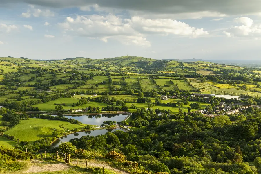 Download a photo of a lush village with a plain arable land 