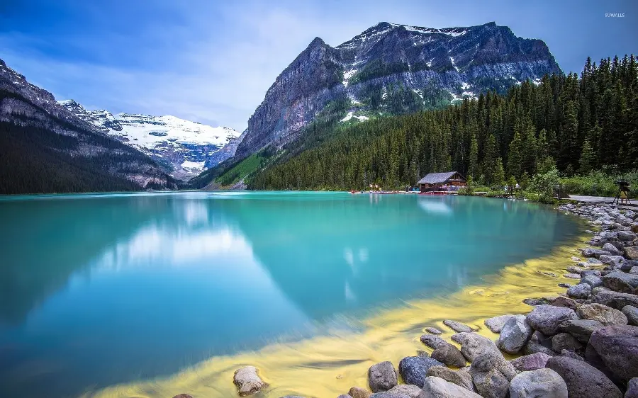 The most beautiful picture of a clear, forested mountain lake with full water in HD quality 