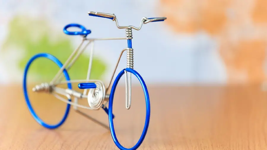 New, classy and luxurious background of a metal bicycle and a funny miniature