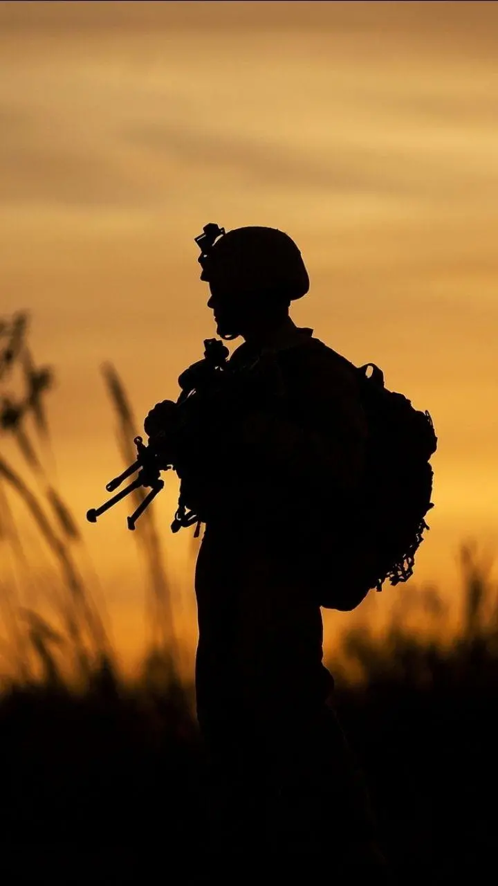 Background photo of a military soldier in the background of the sunset