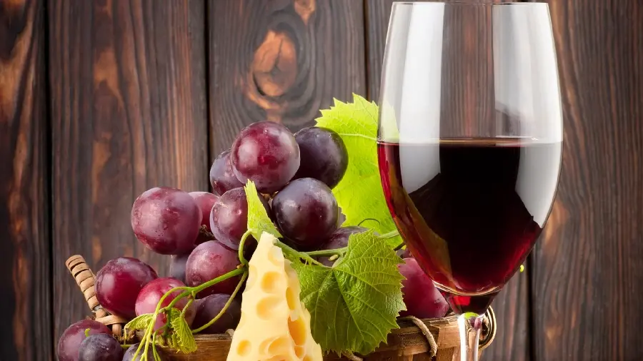 Stylish and luxurious wallpaper of red grapes next to grape juice 