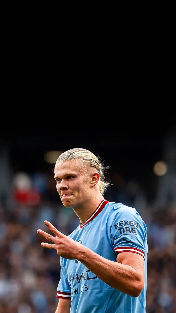 Download Erling Haaland's photo celebrating after a goal with a black background