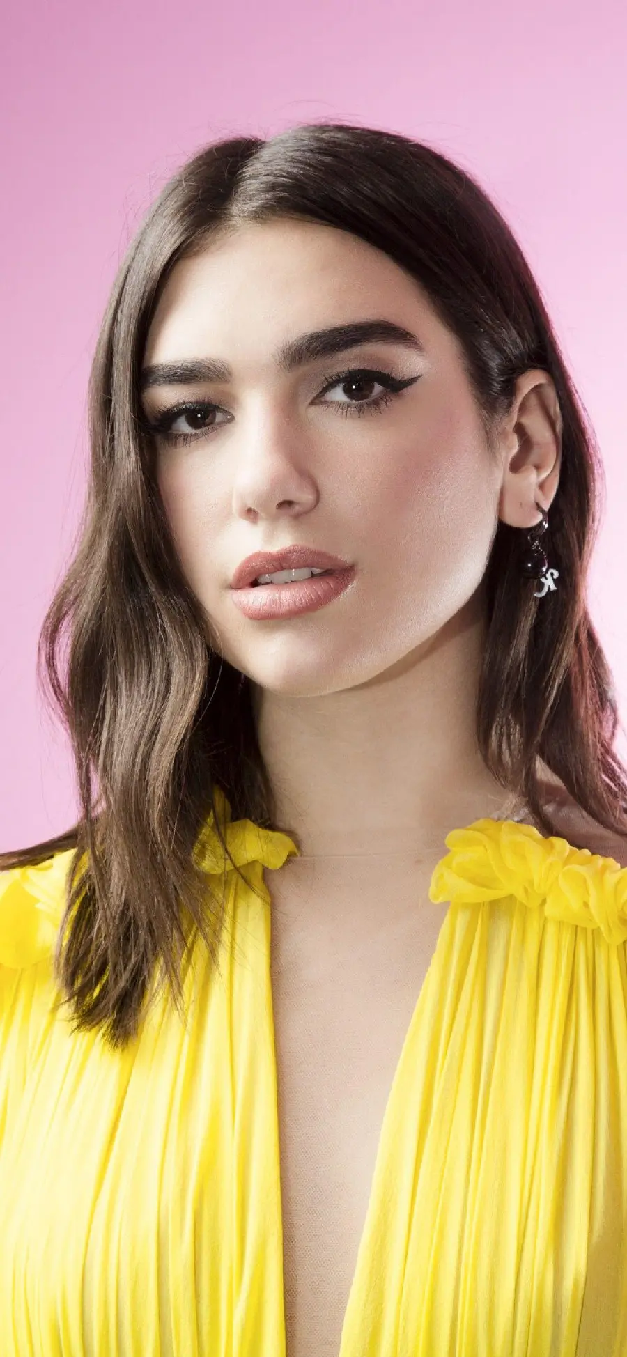 Dua Lipa background image with a stylish style and a lemon yellow dress