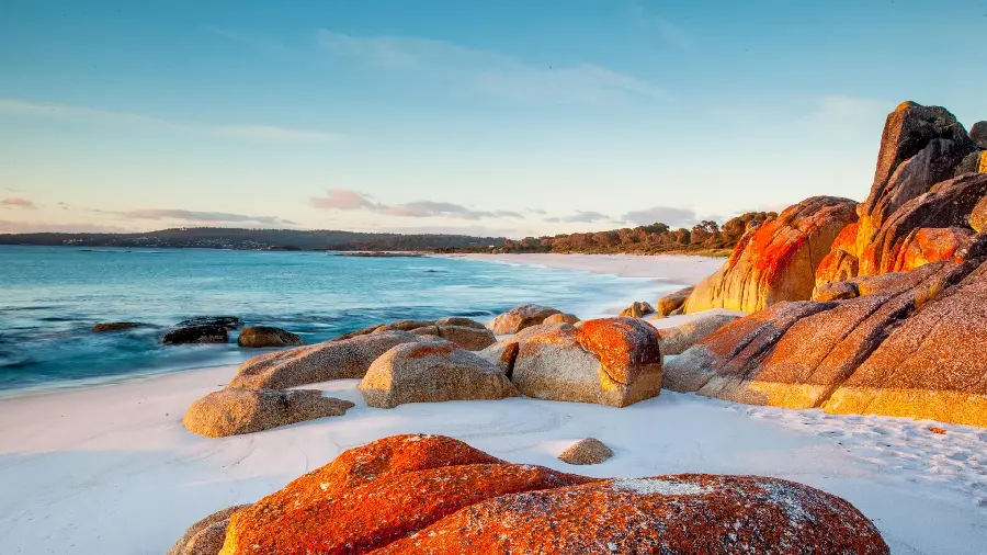 Image of large and small rocks by the beach in the blue sky 2023