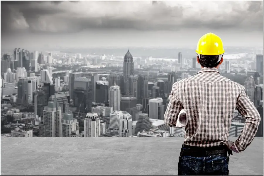 Photo of a civil engineer with a helmet looking at the cityscape for engineer profiles