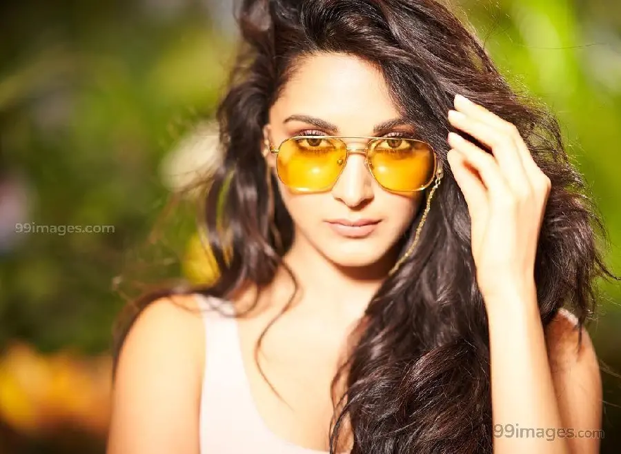 Kiara Advani simple background with sunglasses and long hair 