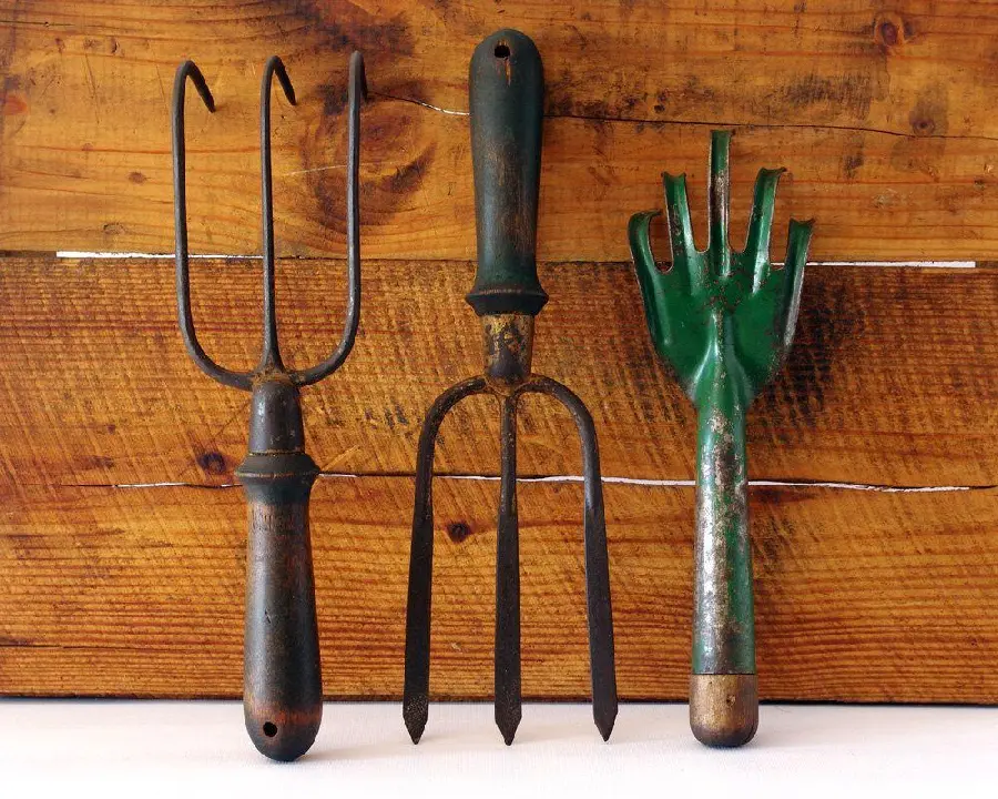 Image of various old garden rakes