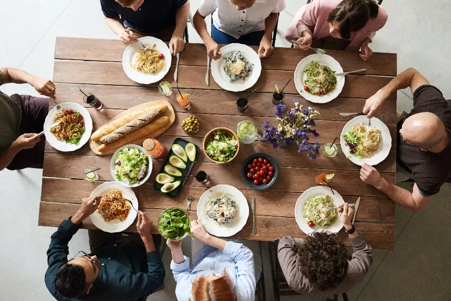 Family sitting around the table and delicious food for desktop and background