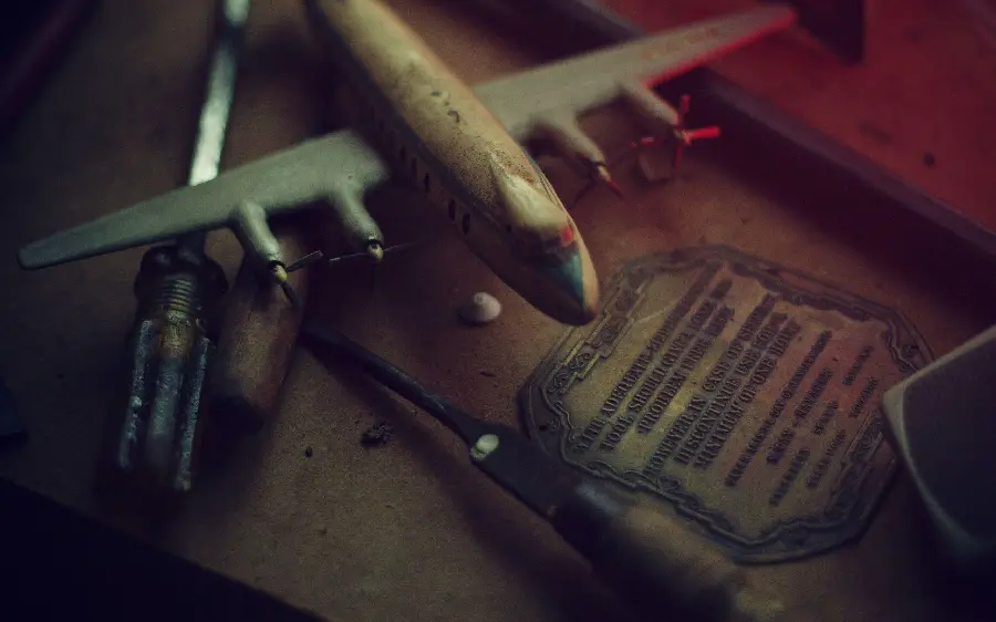 Photo of an old workbench with a miniature and small airplane